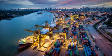 An port with shipping containers being loaded as an example of a business internationally expanding