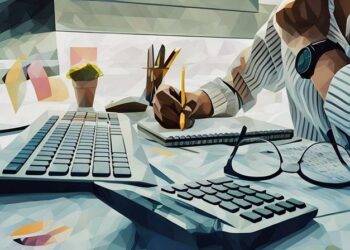 A entrepreneur using a computer, calculator and paper to work out how he can better budget