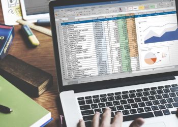 A business person using excel on a laptop to calculating marketing expenditure