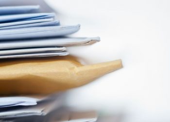 Series of marketing letters and packages with brochures that are about to be sent to prospective customers as part of a marketing campaign