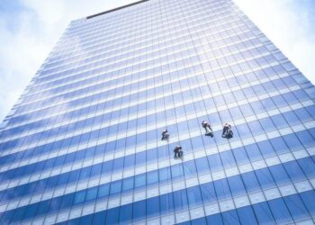 Window cleaners cleaning an office block (skyscraper)