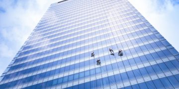Window cleaners cleaning an office block (skyscraper)