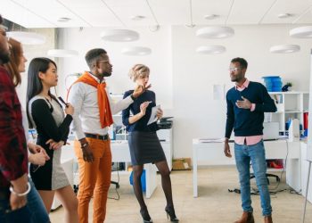 A standing meeting where a colleauge his presenting his ideas to the meeting in the form of a visual whiteboard presentation