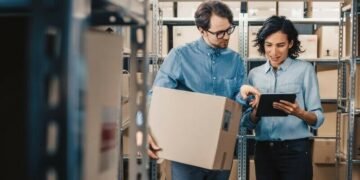 eCommerce entrepreneurs assessing warehouse stock whilst standing in a warehouse