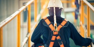 A construction worker attached to a safety line preventing workplace accidents
