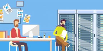 An eCommerce business owner working at his computer while his hosting provide sits next to him taking care of servers where his website is hosted