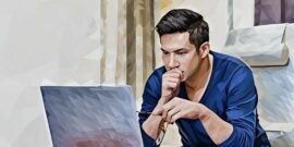 A man staring at a focused way at a laptop holding his glasses