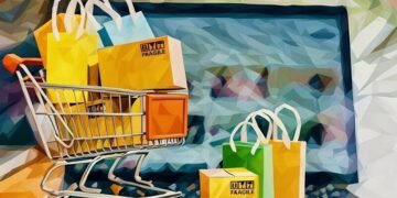 A mini shopping trolley filled with packages in front of a laptop open on an eCommerce website, symbolsing how having the right eCommerce theme can make a difference to sales