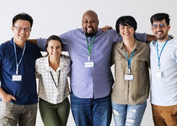 A group of key employees standing together as a team