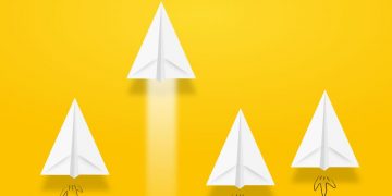 A group of paper aeroplanes with one speeding ahead, showing how a fast website gives you adn advantage in eCommerce