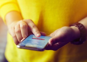 Closeup of a woman using a banking application on her mobile phone