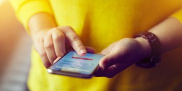 Closeup of a woman using a banking application on her mobile phone
