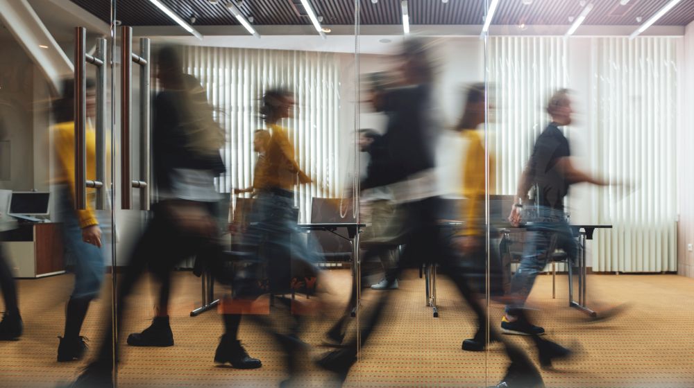 A group of employees walking quickly