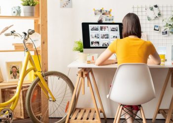 A female working from her home office, sitting at a desk