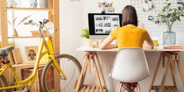 A female working from her home office, sitting at a desk