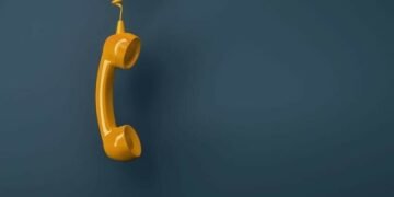A landline phone handset dangling down symbolsiing the negative potential of not retaining customers
