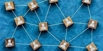 A set of wooden blocks with people sysmbols on them showing a leadership structure