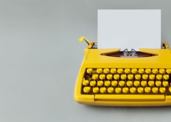 Typewriter with a blank page as an example of how difficult it can be to write the perfect offer letter