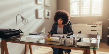 A women working in her home office, sitting at a desk