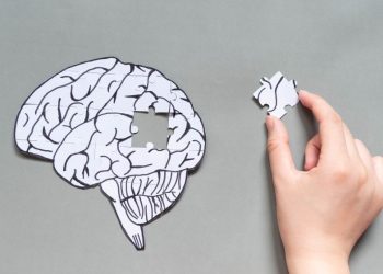 A diagram of a brain with a person holding a missing piece as a metaphor for repairing mental health