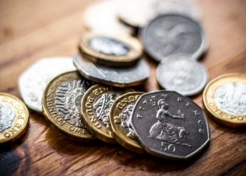 British currency coins spread out a symbol for financing