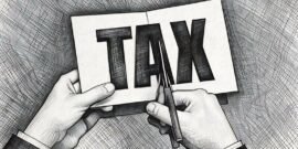 Hands cutting up paper with the word tax on, symbolising how EIS can lessen tax payable for investors