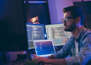 A computer programmer working at a desk on cyber security protection systems to ensure GDPR complance