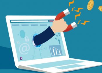 A laptop with examples of ways to make online on screen and a hand reaching out with a magnet, attracting money