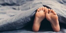 Feet poking out from underneath a weighted blanket