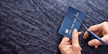 A person cutting up a credit card