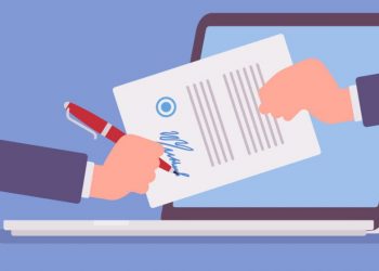 A person signing a grant application and sending it off via laptop