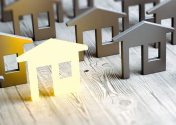 A series of wooden houses representing the housing market