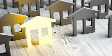 A series of wooden houses representing the housing market