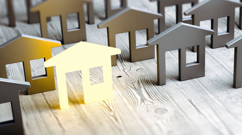 A series of wooden houses representing the housing market