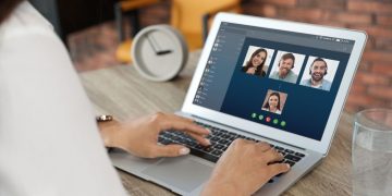 Leader video chatting with team via Zoom