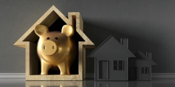 A goiden piggybank in a house model