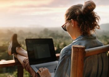 A business woman remote working on a balcony