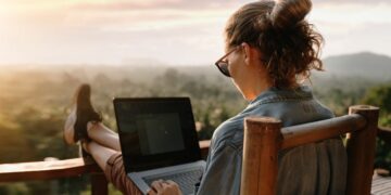 A business woman remote working on a balcony