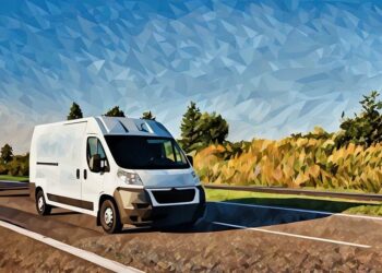 A white commercial van on the road