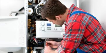 A service man repairing a landlords expensive boiler