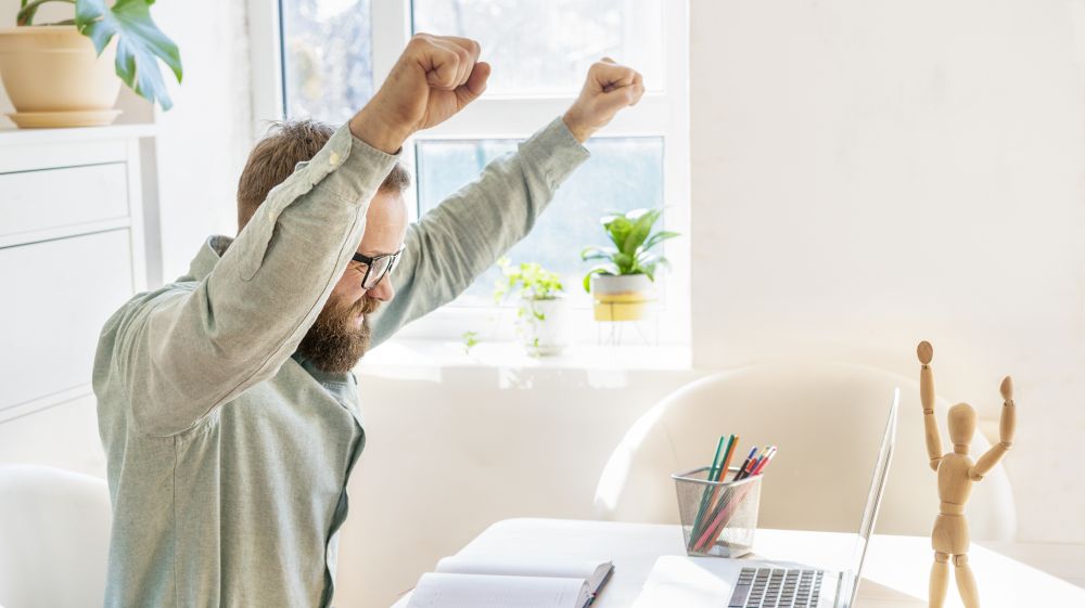 Person celebrating at a desk being hired