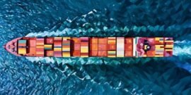 Cargo ship travelling over water symbolising import and export
