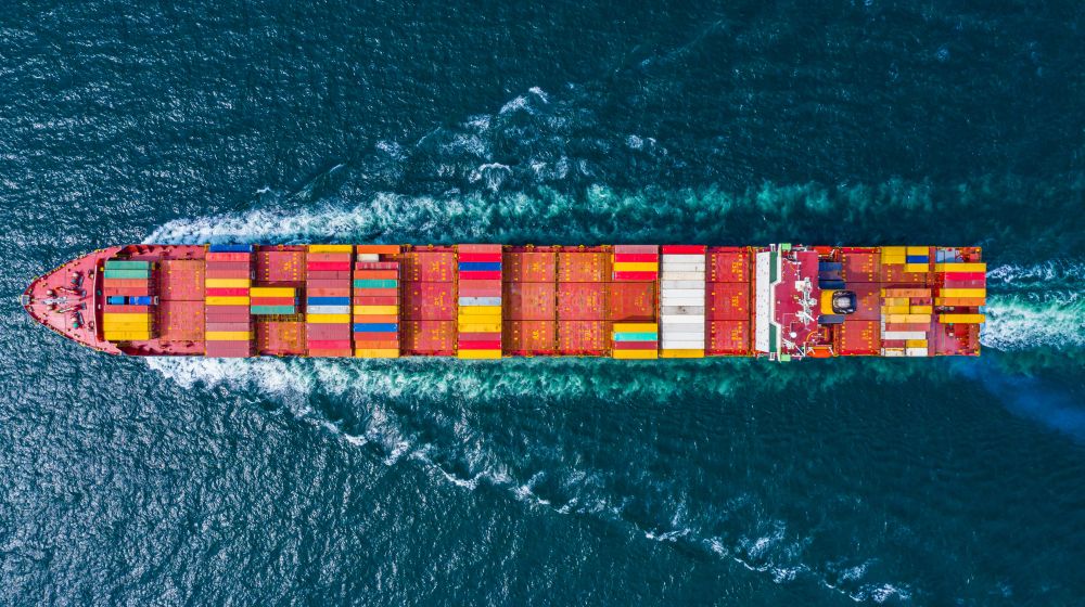 Cargo ship travelling over water symbolising import and export