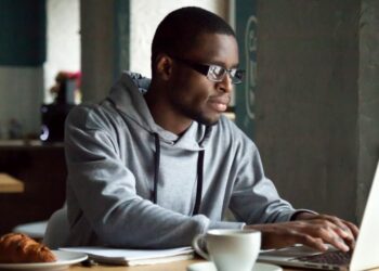 A freelancer working on a laptop at home