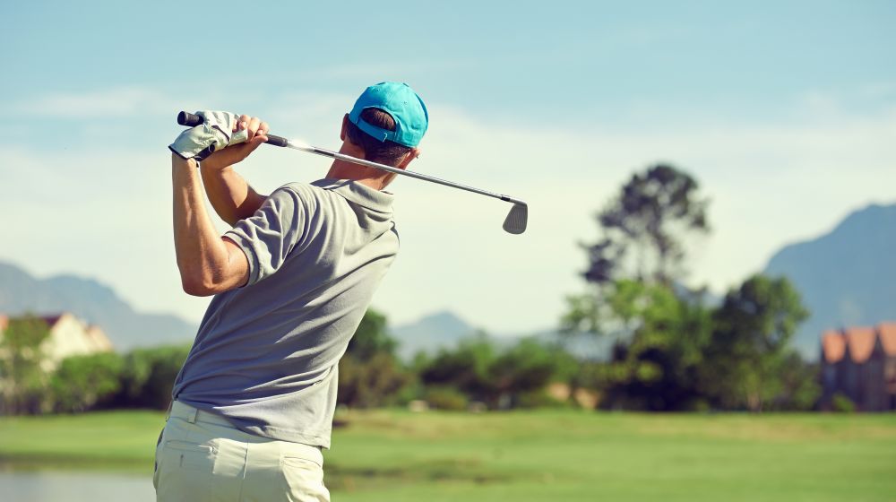 A man taking a gold shot from the green