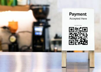 QR Code sign on a counter as an example of a popular method of cashless payment