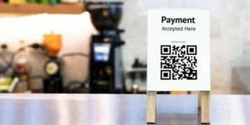 QR Code sign on a counter as an example of a popular method of cashless payment