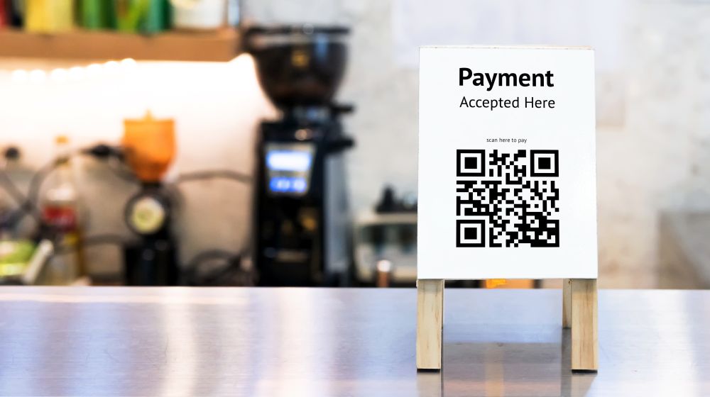 QR Code sign on a counter as an example of a popular method of cashless payment