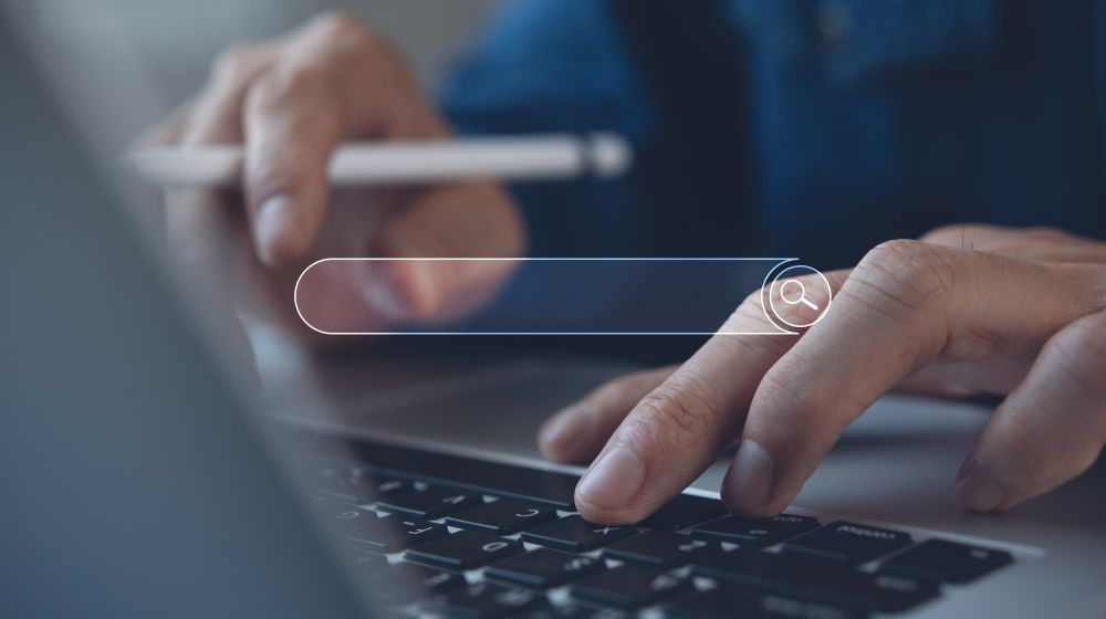 Business person using a laptop to access an enterprise grade search engine