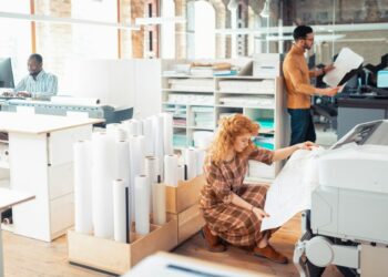 A team of employees working at a printing business